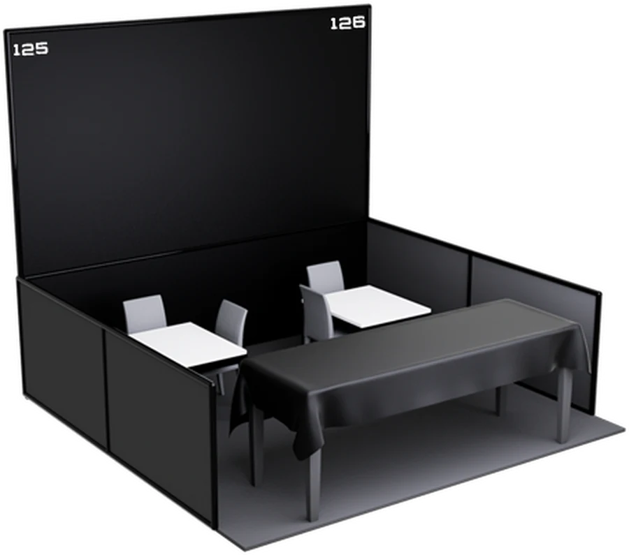 A trading stand at the festival: panelled back and side walls, a dressed table and seating.